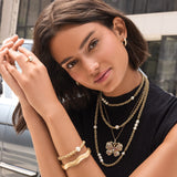 Brighton pearl and gold chain short necklace styled with layered jewelry on model