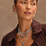 Model wearing Brighton Twinkle Luxe Trio Blue layered silver necklaces with blue stone pendants