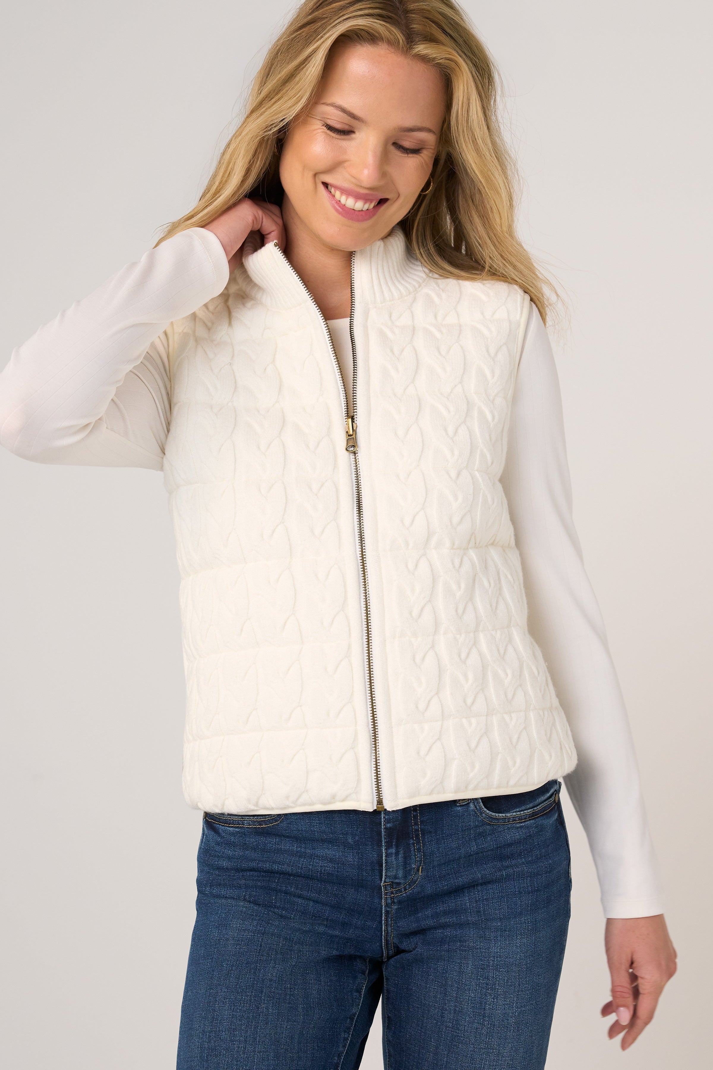 Liverpool Reversible Zip Front Quilted Sweater Vest in cream, worn over white long-sleeve top with jeans