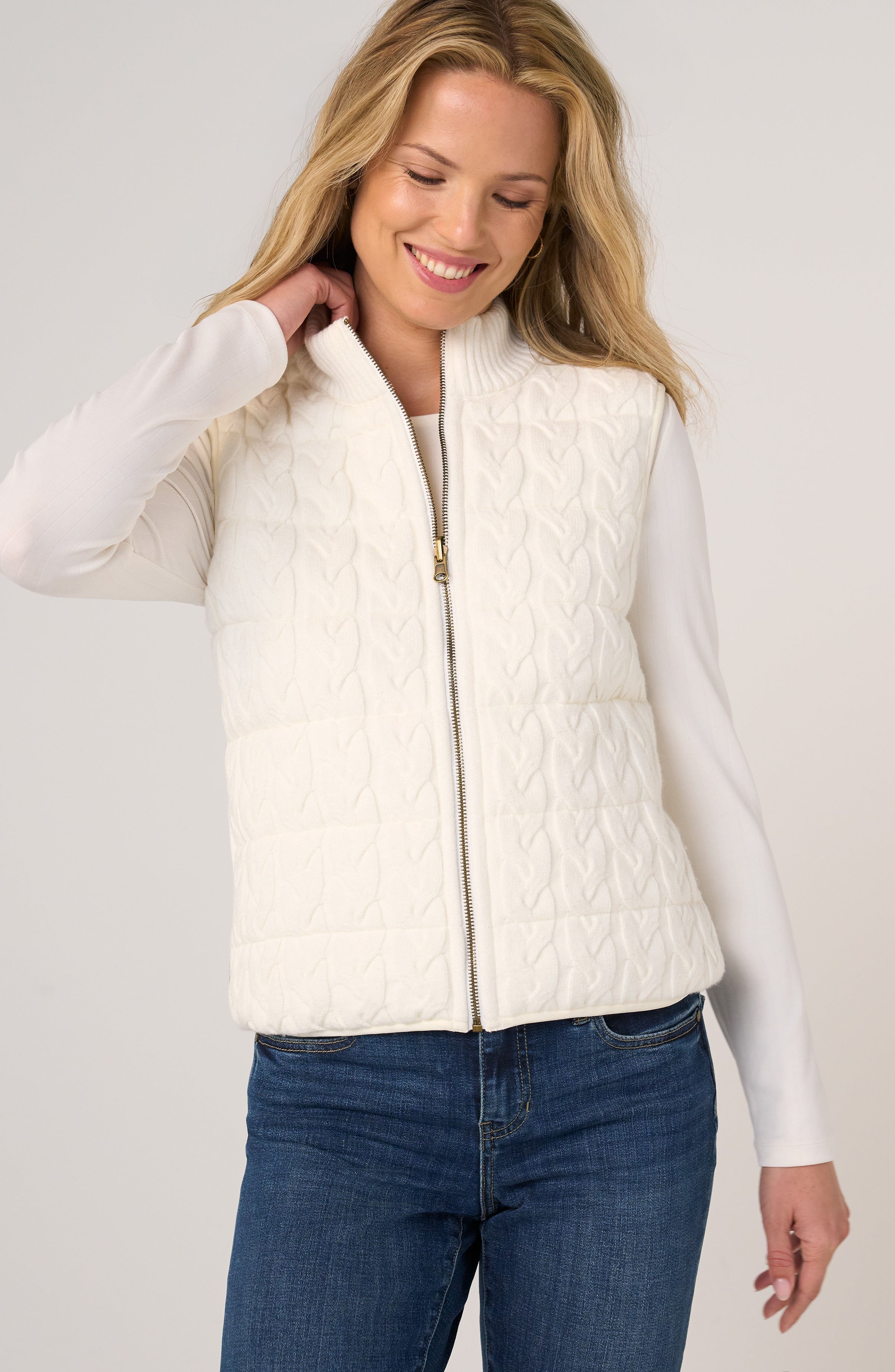 Liverpool Reversible Zip Front Quilted Sweater Vest in cream, worn over white long-sleeve top with jeans