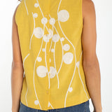 Yellow sleeveless top with cream embroidered circles and button back closure