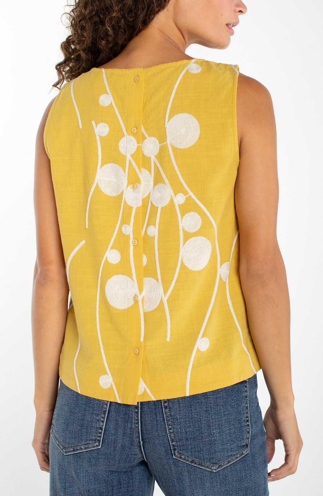 Yellow sleeveless top with cream embroidered circles and button back closure