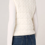 Back view of Liverpool cream cable-knit quilted sweater vest over white long-sleeve top