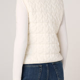 Back view of Liverpool cream cable-knit quilted sweater vest over white long-sleeve top