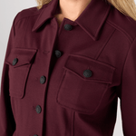 Liverpool Peplum Jacket in dark oxblood burgundy with black decorative buttons and chest pockets