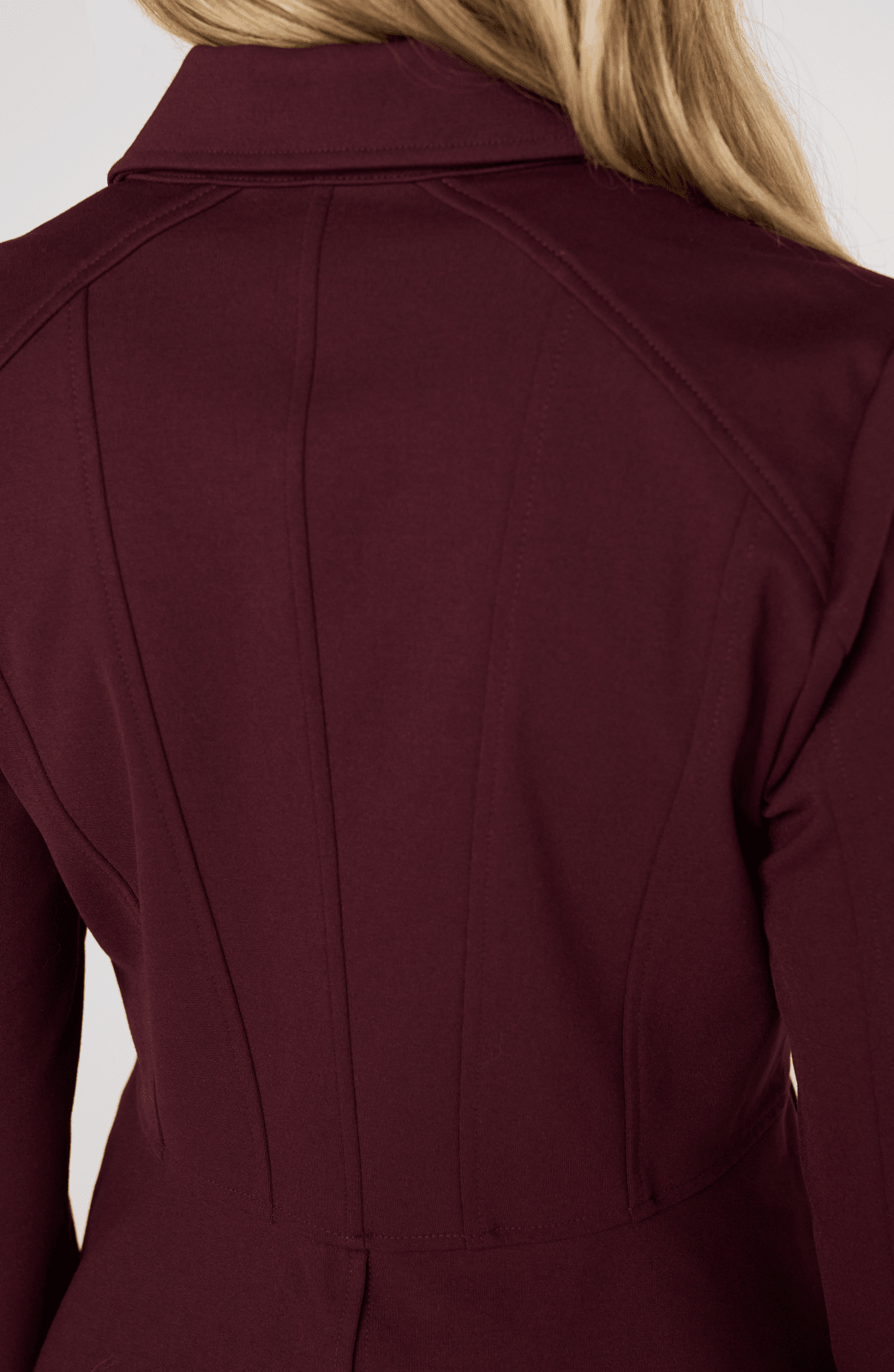 Liverpool Peplum Jacket in dark oxblood shown from back view on blonde model