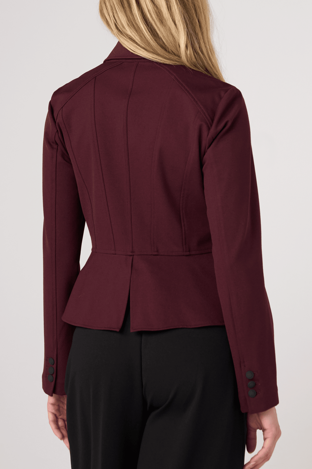 Liverpool Peplum Jacket in dark oxblood shown from rear angle on female model