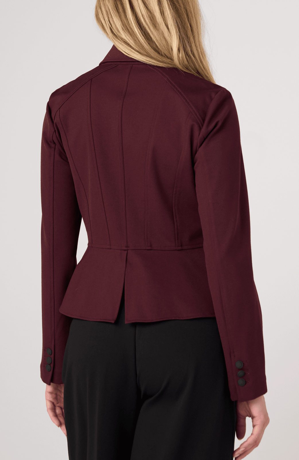 Liverpool Peplum Jacket in dark oxblood shown from rear angle on female model