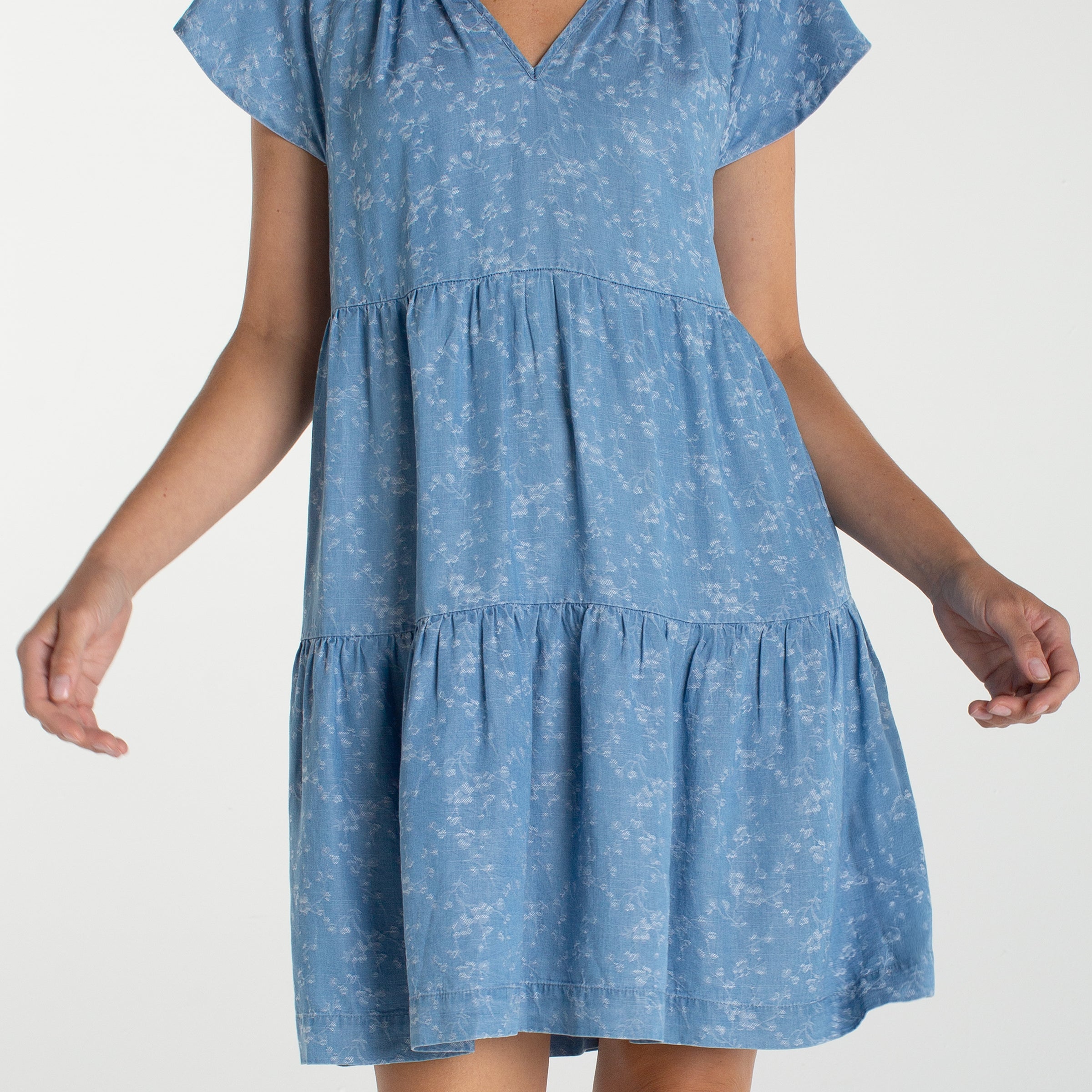Liverpool Los Angeles, denim dress, floral mini dress, tiered dress with pockets, indigo roses, summer flutter sleeve dress, light wash denim dress, feminine casual style. at ooh la la! in 
Grapevine TX 76051