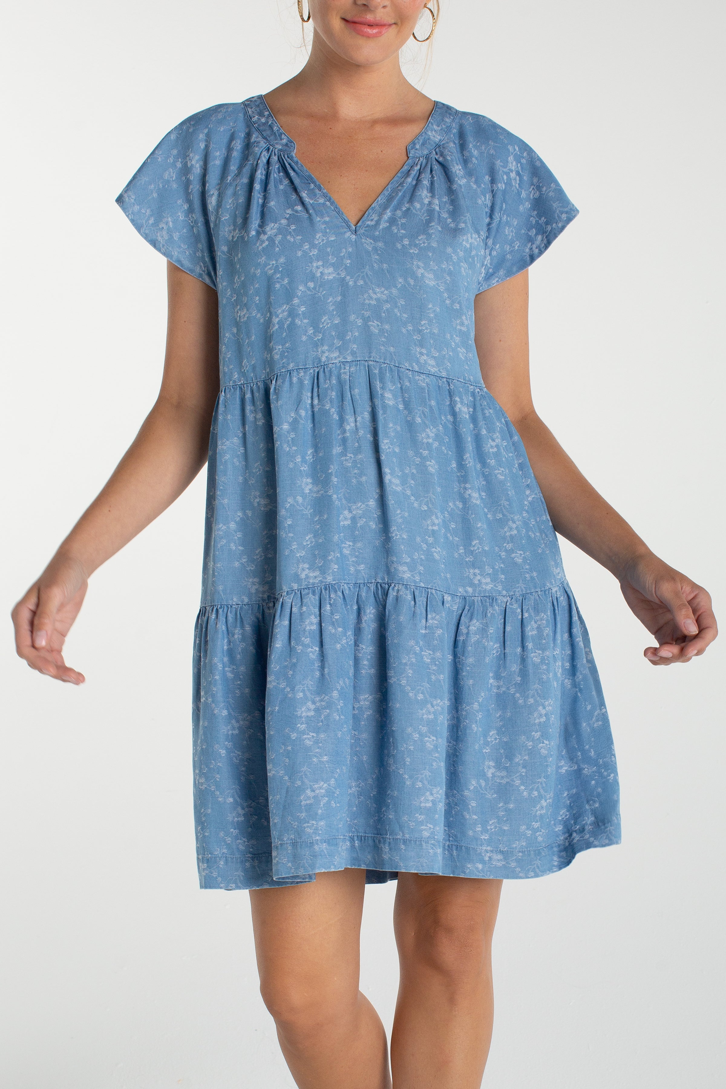 Liverpool Los Angeles, denim dress, floral mini dress, tiered dress with pockets, indigo roses, summer flutter sleeve dress, light wash denim dress, feminine casual style. at ooh la la! in 
Grapevine TX 76051