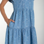 Liverpool Los Angeles, denim dress, floral mini dress, tiered dress with pockets, indigo roses, summer flutter sleeve dress, light wash denim dress, feminine casual style. at ooh la la! in 
Grapevine TX 76051