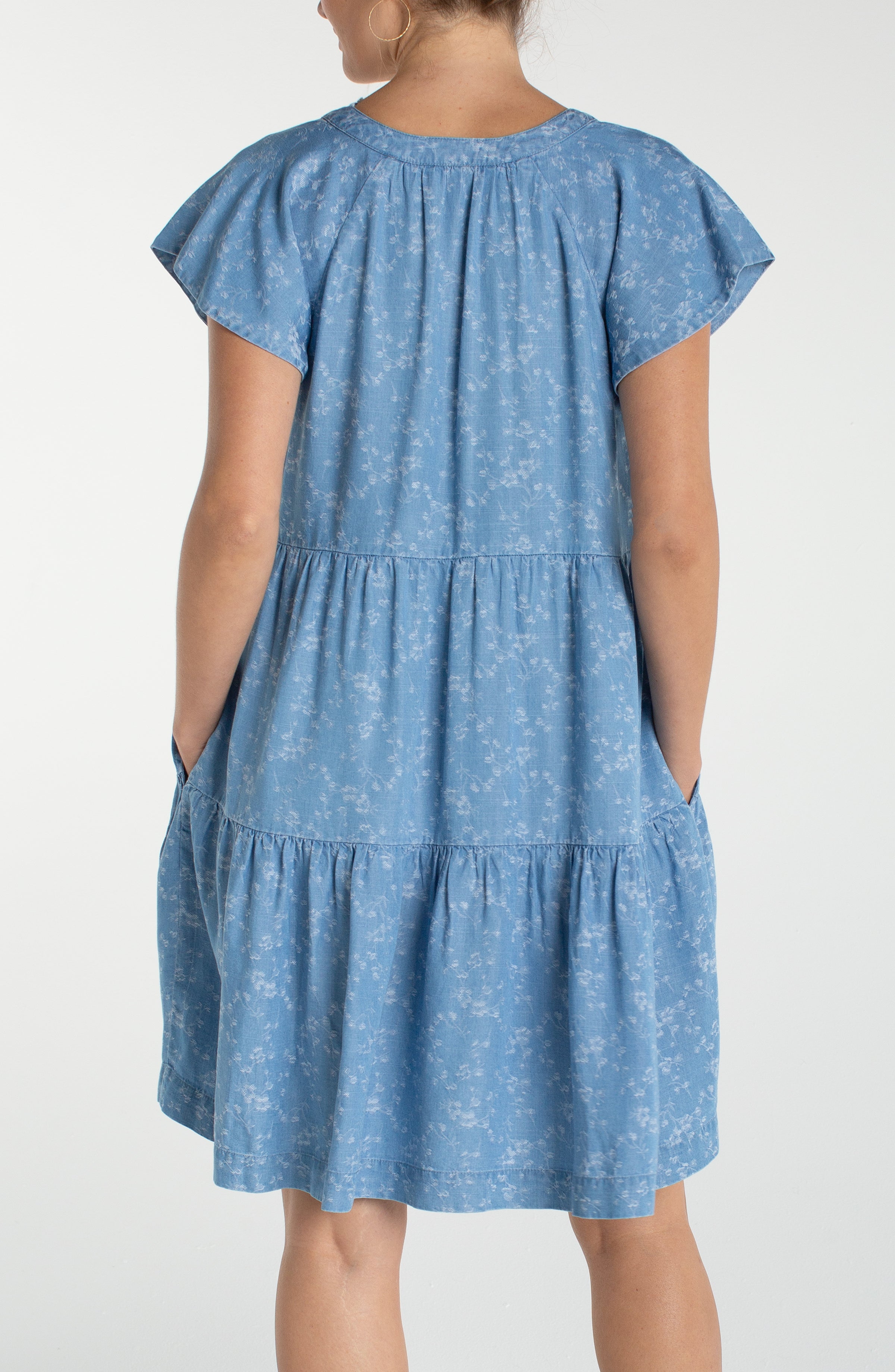 Liverpool Los Angeles, denim dress, floral mini dress, tiered dress with pockets, indigo roses, summer flutter sleeve dress, light wash denim dress, feminine casual style. at ooh la la! in 
Grapevine TX 76051